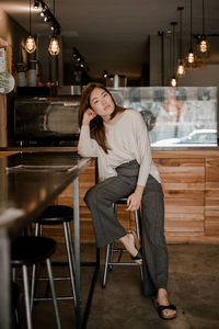 Portrait of woman sitting on chair