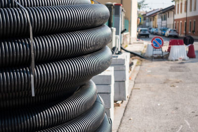 Close-up of metal pipes on street in city