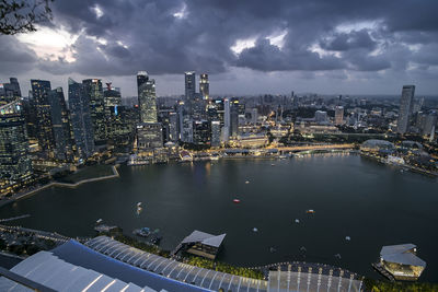 High angle view of river amidst buildings in city against sky