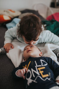 Sister kissing young brother