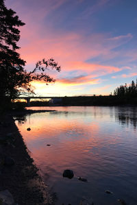 Scenic view of lake against orange sky