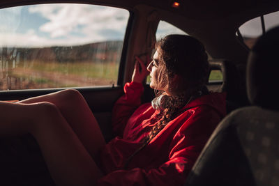 Young woman relaxing in car