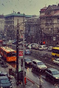 Cars on road in city during winter