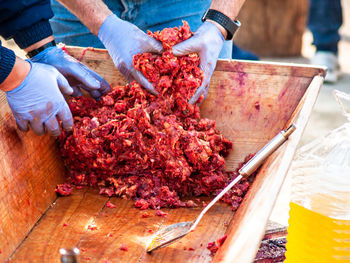 Midsection of person working on table at market