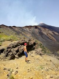 Full length of woman standing on mountain against sky