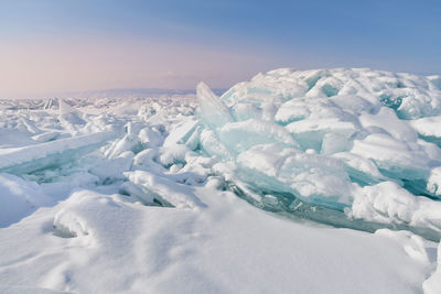 Scenic view of glaciers against sky during sunset