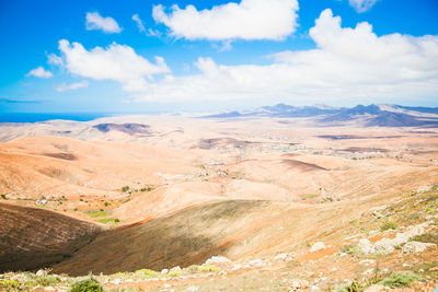 Scenic view of landscape against cloudy sky