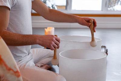 Midsection of man praying at yoga studio