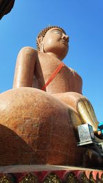 Low angle view of statue against blue sky