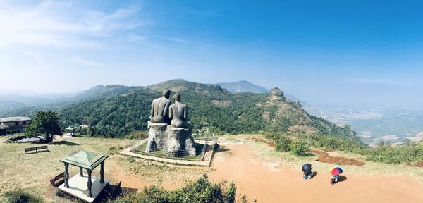 Panoramic view of statues on mountain against sky
