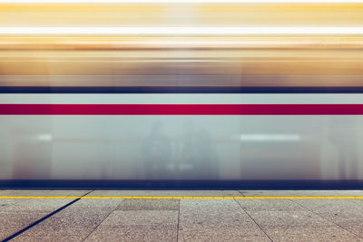 Blurred motion of train at railroad station