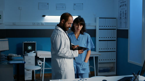 Portrait of young woman standing in laboratory