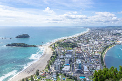 High angle view of sea and buildings against sky