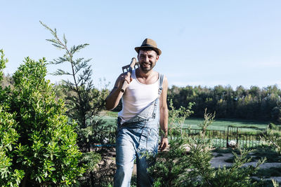 Man standing by plants against sky