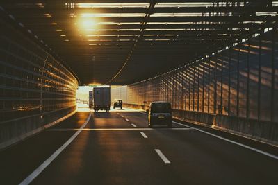 Cars in illuminated tunnel