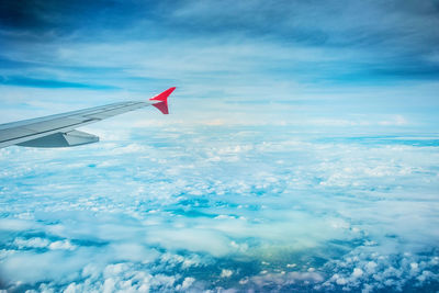 Airplane flying over sea against sky