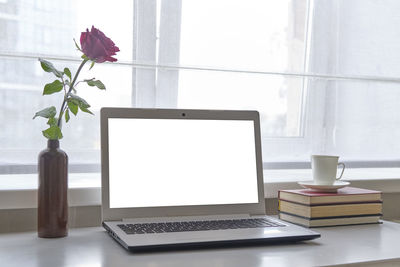 Flower vase on table at home