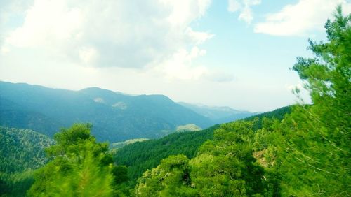 Scenic view of mountains against cloudy sky