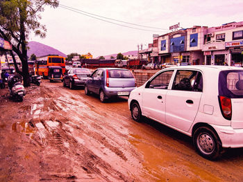 Car on street against buildings in city