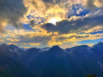 Scenic view of snowcapped mountains against sky during sunset