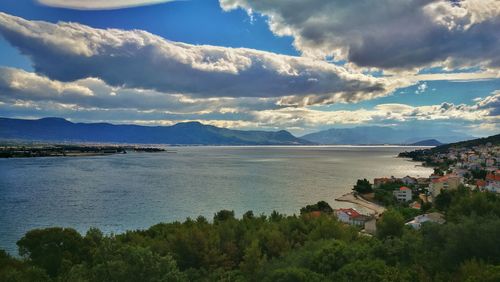 Scenic view of sea and mountains against sky