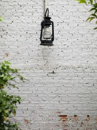 Low angle view of electric lamp mounted on wall