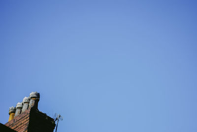 Low angle view of statue against blue sky