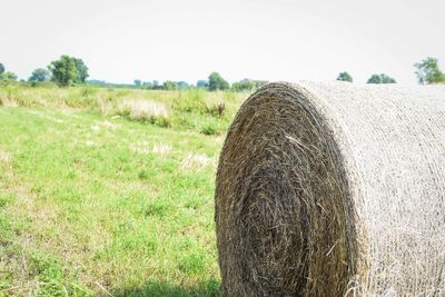 Hay bales on field against sky