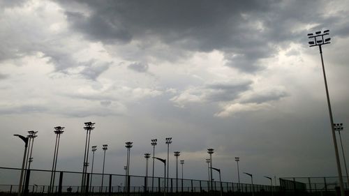 Low angle view of street light against cloudy sky