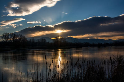 Scenic view of lake against sky during sunset