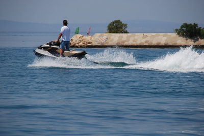 Man riding jet boat in sea