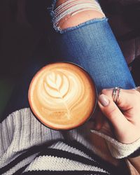 Midsection of woman with coffee cup