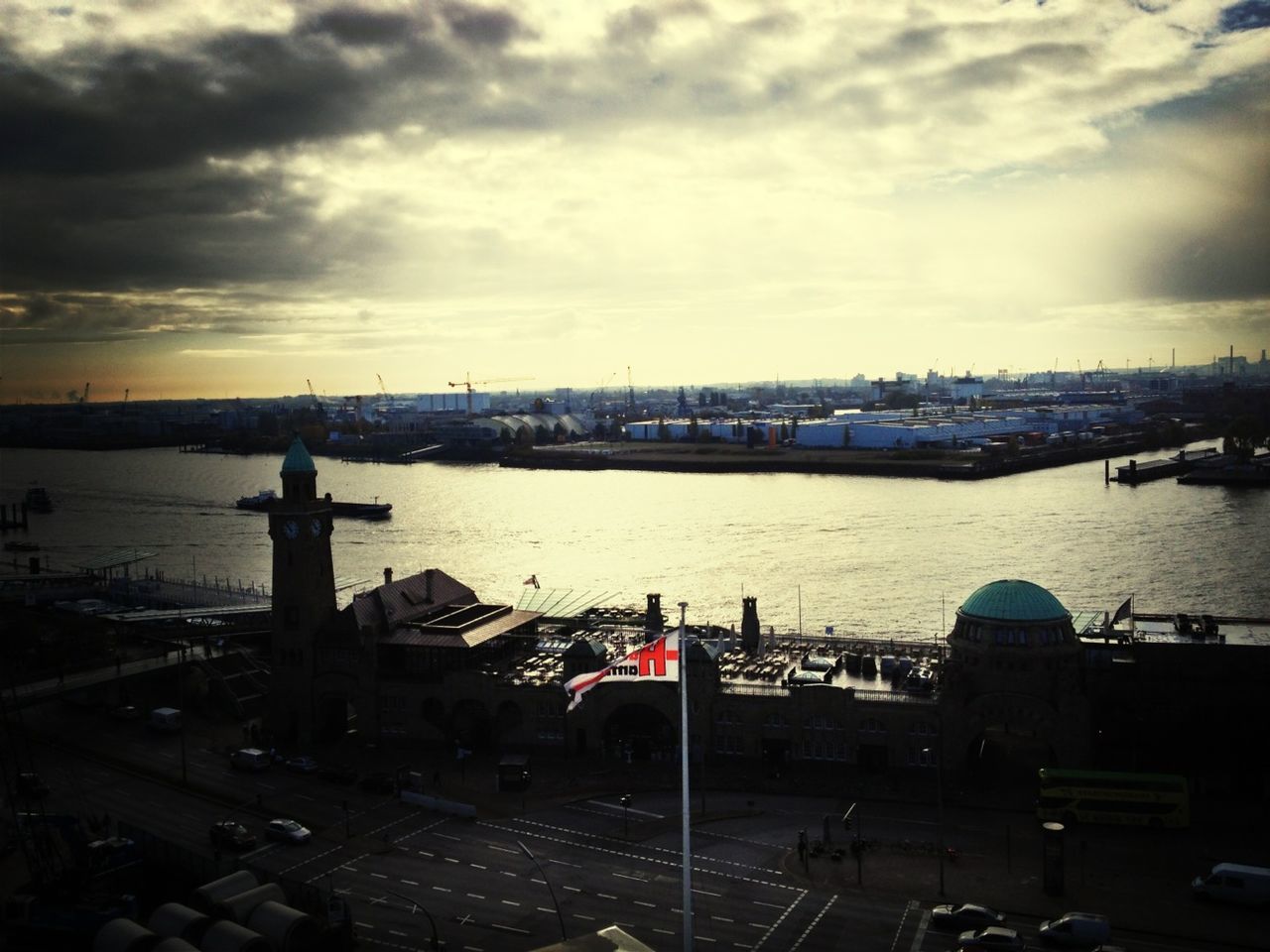 sky, transportation, harbor, nautical vessel, building exterior, water, built structure, mode of transport, architecture, cloud - sky, sea, city, commercial dock, crane - construction machinery, cloudy, cityscape, moored, river, cloud, boat