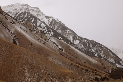Scenic view of snowcapped mountains against clear sky