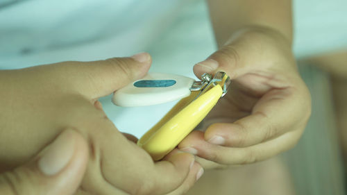 Close-up of boy holding nail clipper