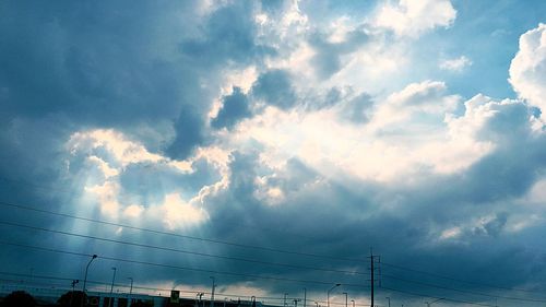 Low angle view of electricity pylon against sky