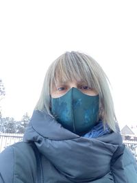 Portrait of woman with snow covered against sky