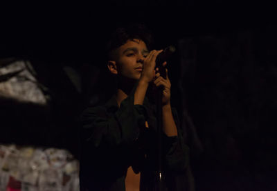 Young man singing during concert