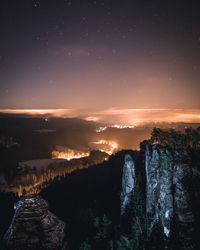 Scenic view of illuminated landscape against sky at night