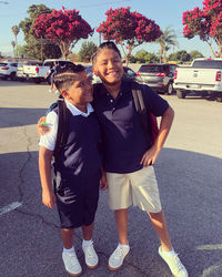 Portrait of happy friends standing on road