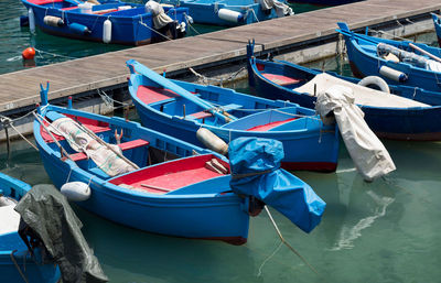 High angle view of fishing boats moored at harbor