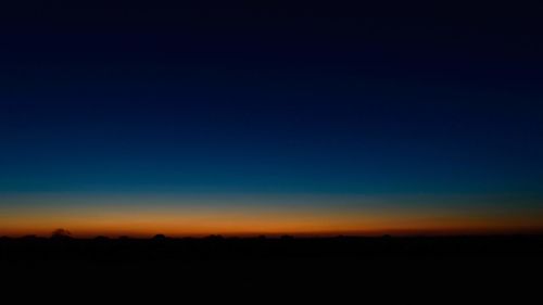 Scenic view of silhouette landscape against clear sky at sunset