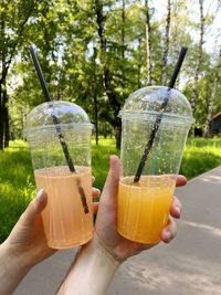 Cropped hand of woman holding drink