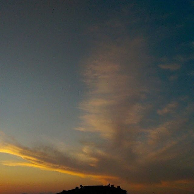 sunset, sky, silhouette, cloud - sky, low angle view, orange color, beauty in nature, scenics, tranquility, tranquil scene, nature, cloudy, cloud, idyllic, dramatic sky, dusk, outdoors, moody sky, no people, weather