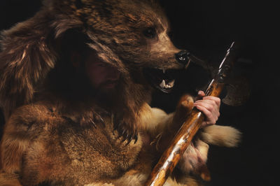 Close-up of young woman holding stick