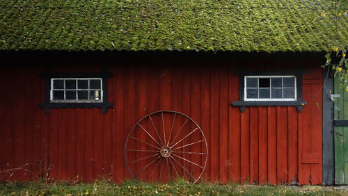 Wheel leaning on the wall of an old rustic house