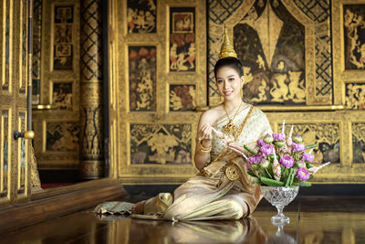 Portrait of a young woman sitting in temple