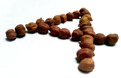 Close-up of coffee beans against white background