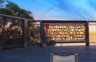 Close-up of illuminated railing against sky