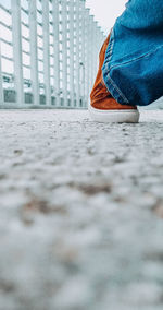Low section of person standing on floor in city